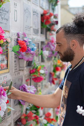 Bechir placing flowers at a memorial